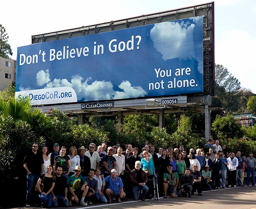 Members of San Diego CoR pose with their billboard which appeared in November and December 2009.