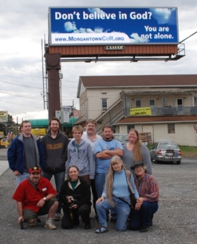 Some of the members of Morgantown CoR in West Virginia pose under their billboard which appeared in September and October 2009.